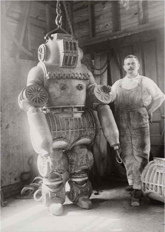 27.) Chester E. Macduffee next to his newly patented, 250 kilo diving suit (1911).