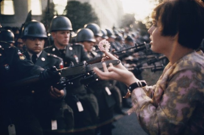 1.) In 1967, 17-year-old Jan Rose Kasmir offers a flower to soldiers during an anti-war protest outside the Pentagon.