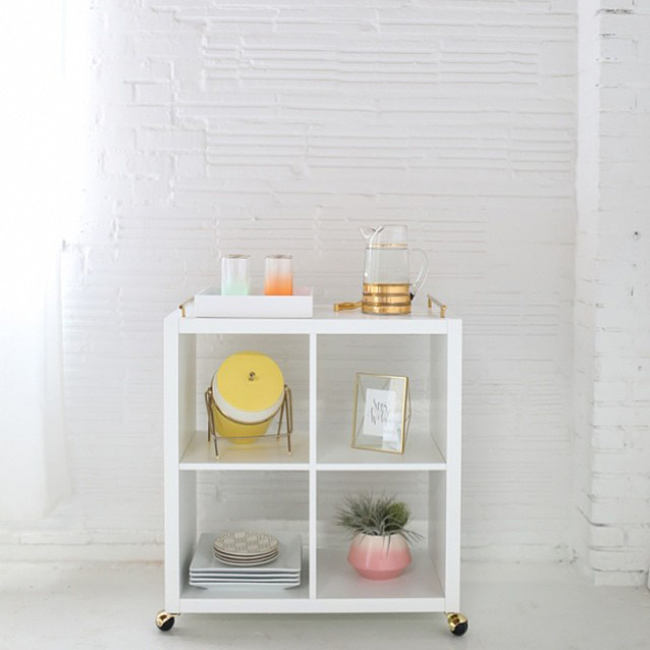 2.) Slap some wheels on a small shelf to transform it into a sweet <a href="https://sugarandcloth.com/2014/05/diy-ikea-hack-bar-cart/" target="_blank">bar cart</a>.