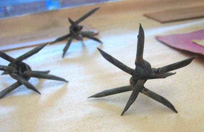 14.) Caltrops: These spikes could be made from bent nails or other metals. They would be used to slow down the advance of horses, camels, elephants or human troops.