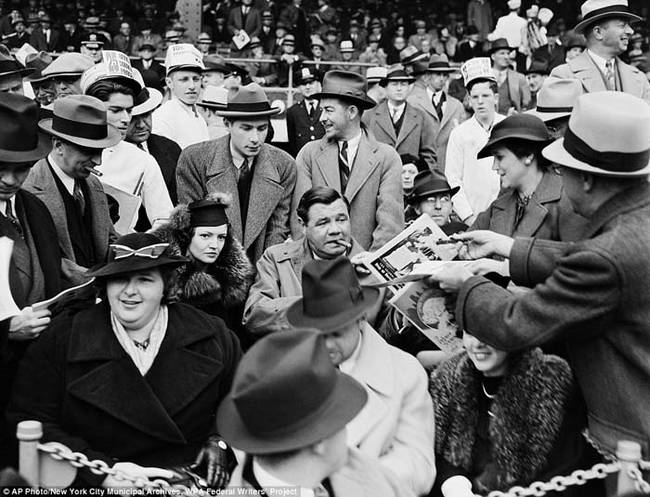 5.) Babe Ruth signing autographs at a baseball game in 1936.