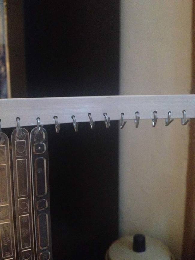 He then drilled holes in a metal bar and added staples for hanging.