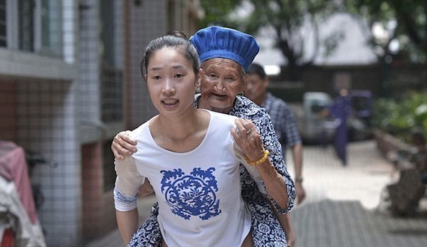 On days when her grandmother isn't feeling up to walking the near-mile long trek, Lihua carries her the distance.