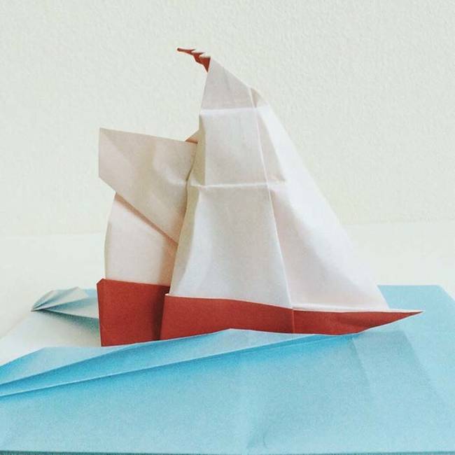 Origami ship sailing across the seas.