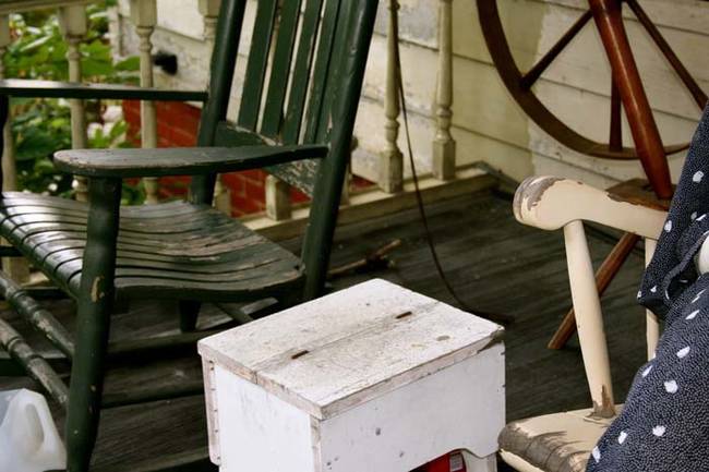 The neighbors have sometimes reported seeing a faint light in the kitchen at night, and there is a vegetable garden out back. The mannequins also disappear on rainy days. So it would seem like someone lives at the house.