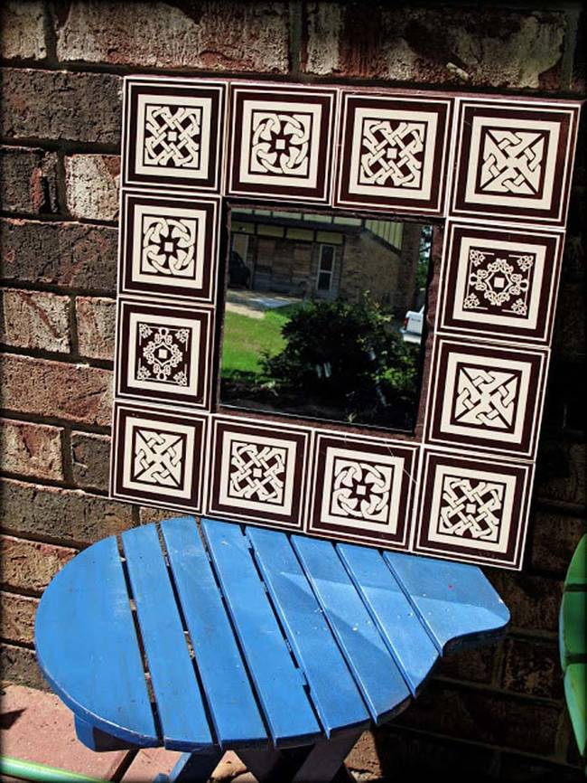 14.) Dollar store tiles and an old mirror make up this outdoor garden accessory.