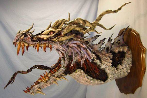 Dragons, both "trophy" heads like these and full-body statues are a large part of Reeder's work.