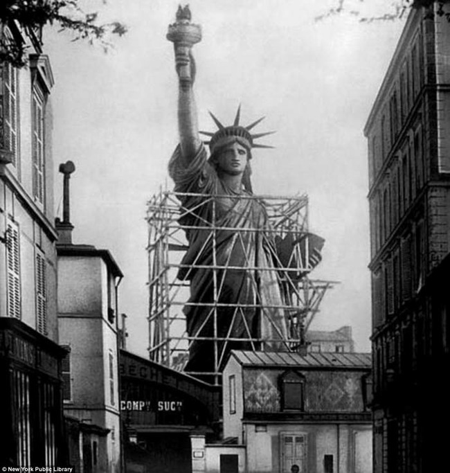 16.) The Statue of Liberty surrounded by scaffolding as workers complete the final stages in Paris (1885).