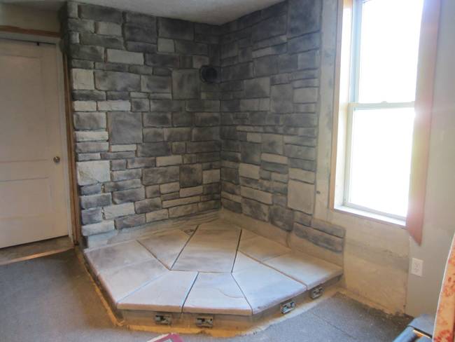 After the wall and the base were constructed, he then used a darker grout to give more definition to the stones.