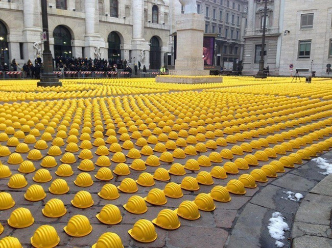 Factory workers lay down their hard hats in the streets of Italy.