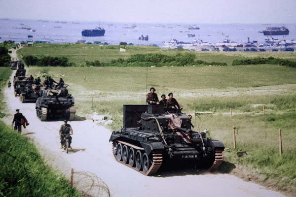 A Cromwell tank leads British soldiers away from their landing point on Golden Beach.