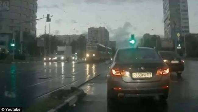 Just a normal rainy day. The light turns green, and this traffic lane makes their move to go.