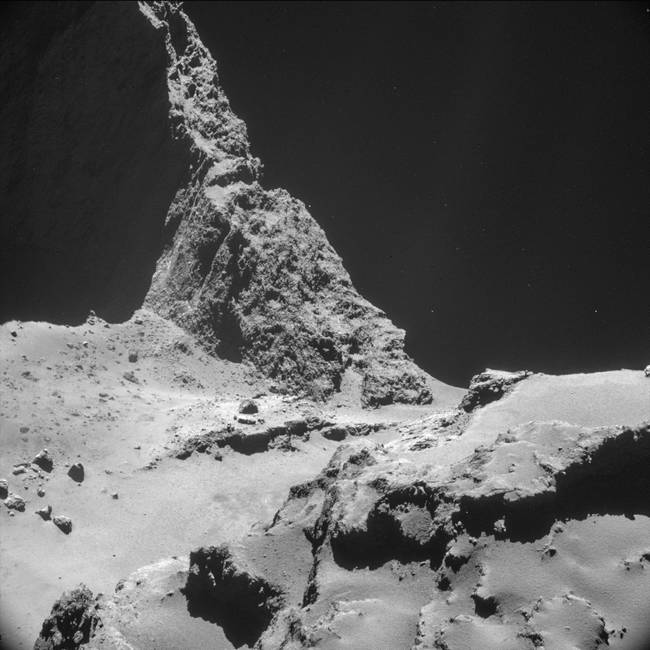 The comet's surface is varied, and overlooks the emptiness of space.