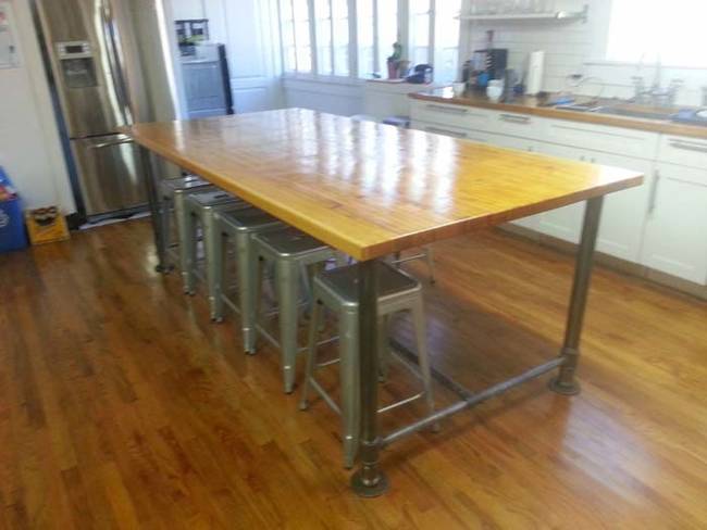 He installed iron legs and finished the surface with stain and gloss.