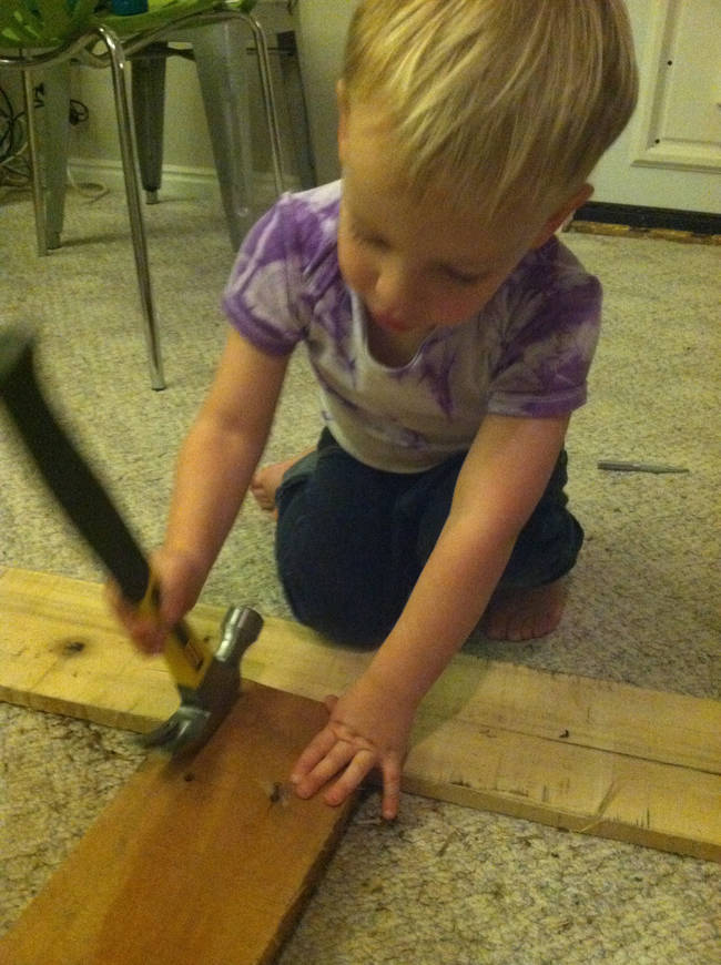 The first step was to take apart the pallets and remove the nails. Everyone in the family got involved, including the young son.