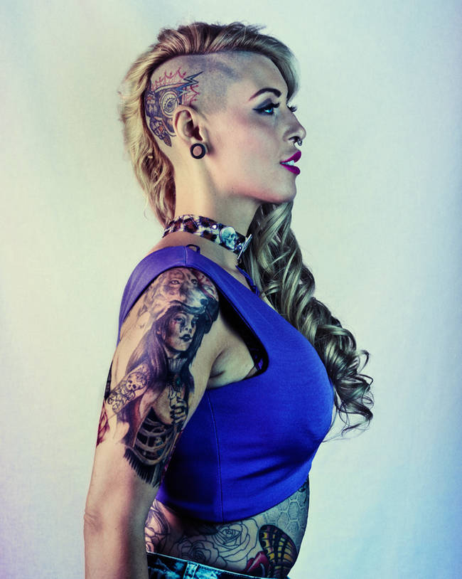 This woman sports a modern take of the classic "pinup" tattoo on her arm.