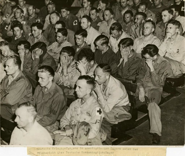 32.) Nazi soldiers react as they are forced to watch footage from concentration camps.