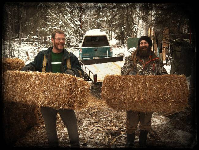 Helpers with the all-natural insulation: straw.