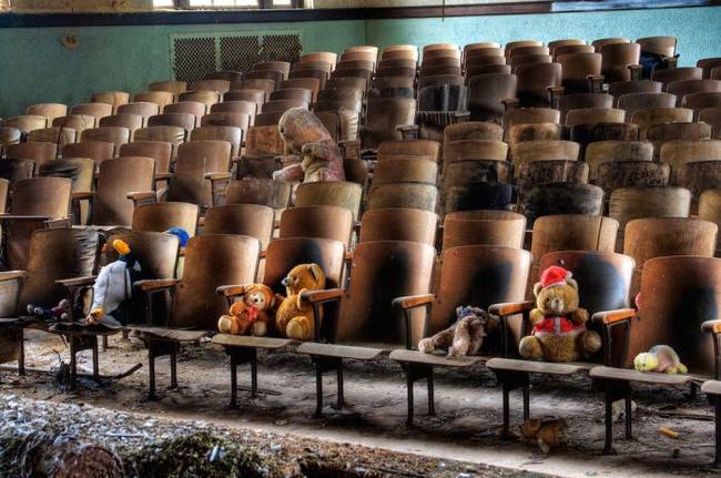 In the auditorium, it is tradition photographers and urban explorers to leave stuffed animals in the seats as eternal spectators to the decay.