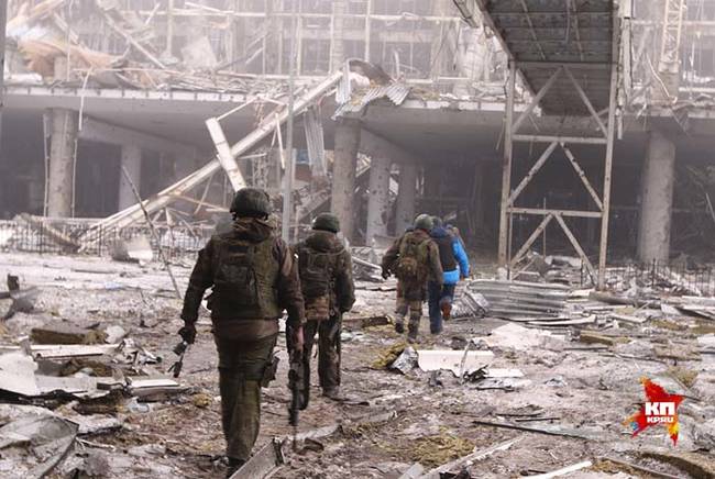 Rebels walking through the ruins.