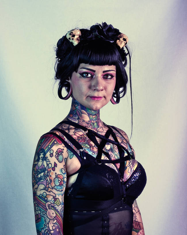 Despite her rather severe outfit, this lady's cutesy tattoos show a softer side.