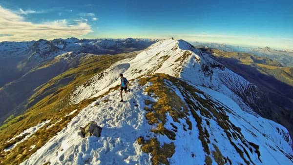 8.) An explorer runs along the summit of a mountain (Les Contamines-Montjoie, France).