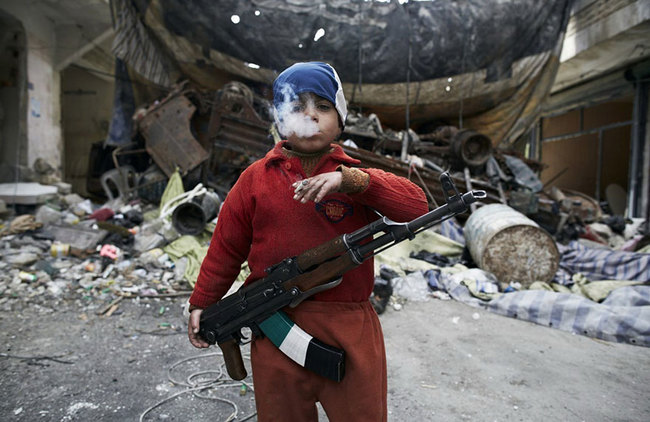 19. Lost Innocence - He's an 8 year old Syrian rebel. Seriously.