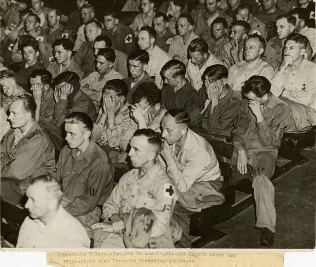 16.) German soldiers watching footage of concentration camps in 1945.