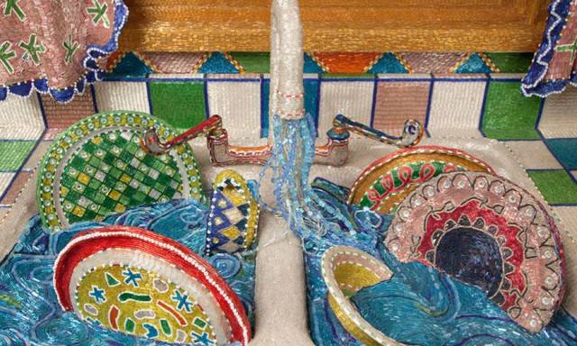 The sink is full of beaded water and dishes.