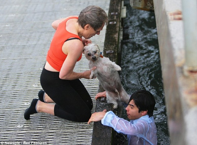 13.) Raden Soemawinata coming out of the frigid water he jumped into to save Bibi the dog, who was blown off the pier by high winds.