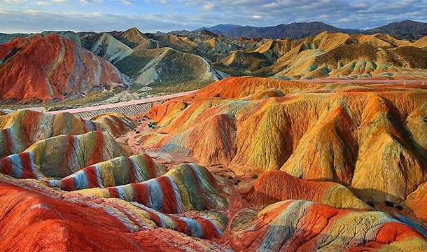 7. Danxia Landforms: Over millions of years, the red sandstone and mineral deposits in certain areas of China have created these rainbow-like landforms.