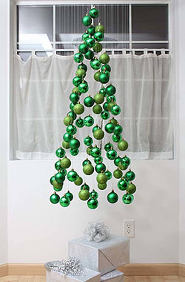 Hang ornaments from the ceiling for a modern tree mobile.