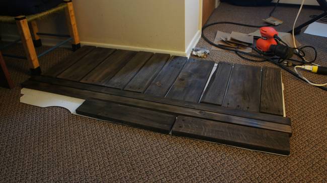 The project began with a lot of re-staining and refinishing of the table, as well as this piece of a wood pallet that served as a lower level for the table.