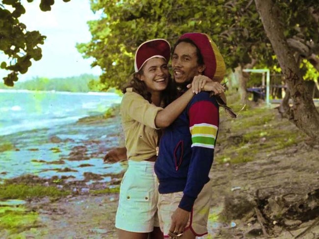 36.) Bob Marley on the beach with Miss World 1976 Cindy Breakspeare (mother of Damien Marley).