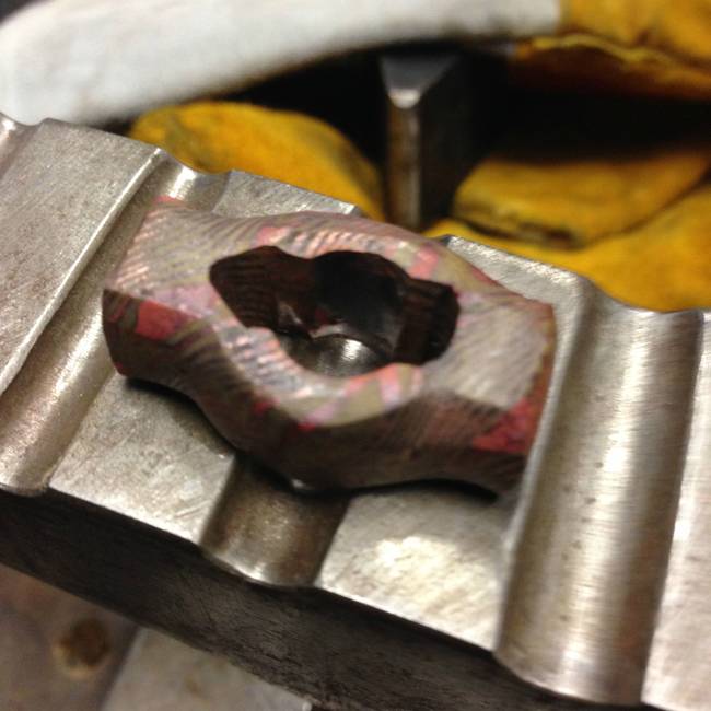 Once the metal was twisted into its desired pattern, it was time to start shaping it into a ring. He cut an opening in the center and here it is starting to look more like a ring.