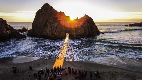 28.) The sun setting behind the Keyhole Arch at Pfeiffer Beach (Big Sur, California).