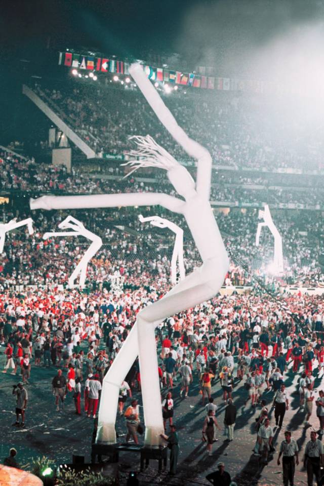 Minshall's "tall boys" dancing at the 1996 Olympics in Atlanta. Unlike their descendants, these tube men have two feet instead of a single stem.