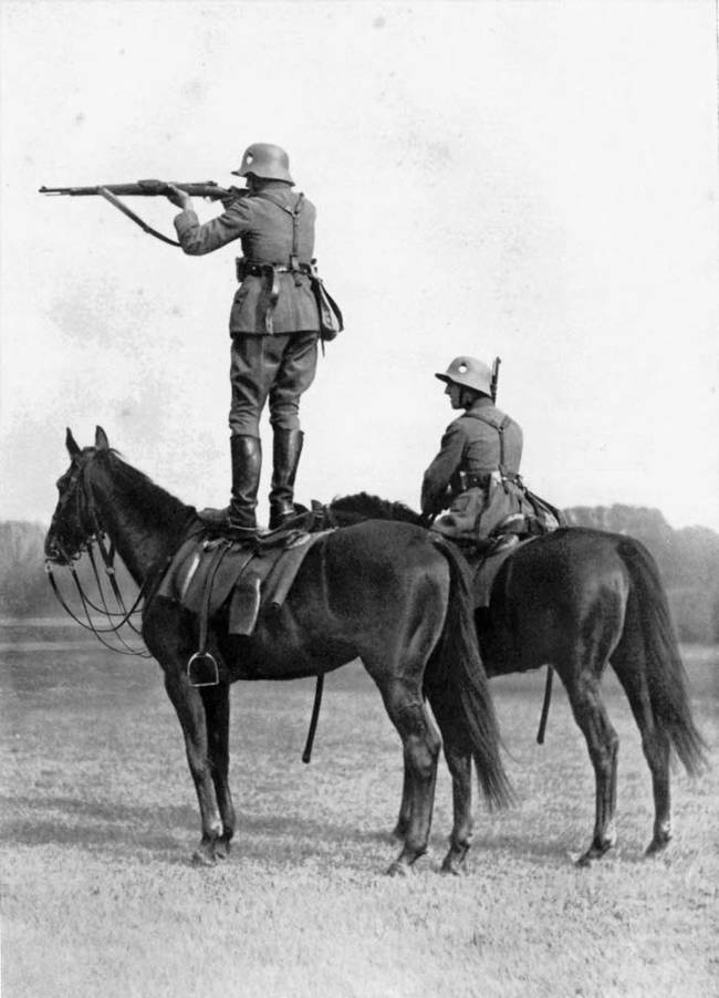 German soldiers in 1935 doing some horseback target practice.