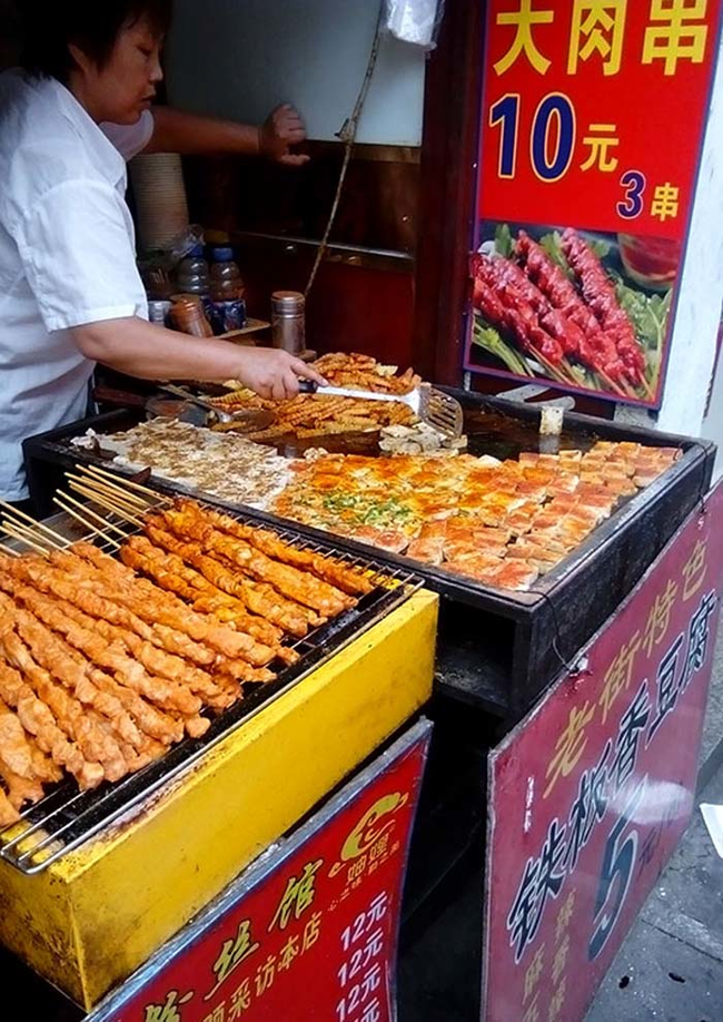 Meat skewers, Chinese fries and fermented tofu squares are fired on these grills.