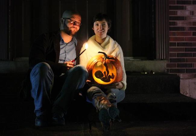 This is a cute picture, but I hope they didn't actually decorate their home with this pumpkin. Spooky!