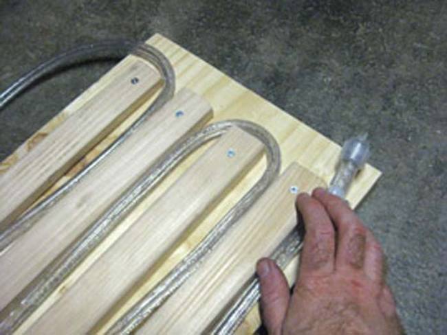 Starting at the bottom right corner of the plywood board, wrap your rope lights through the planks. 