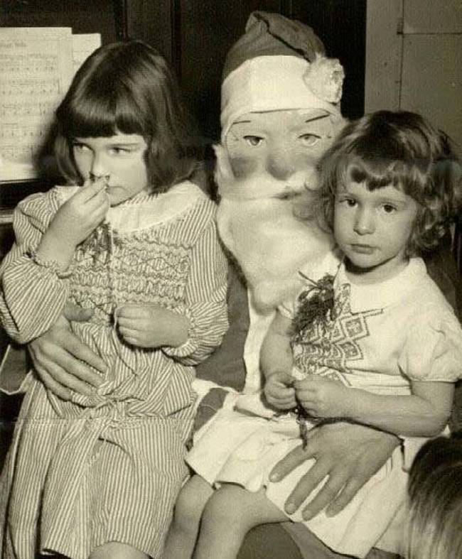 These children are surprisingly calm considering the creepy level of this Santa.