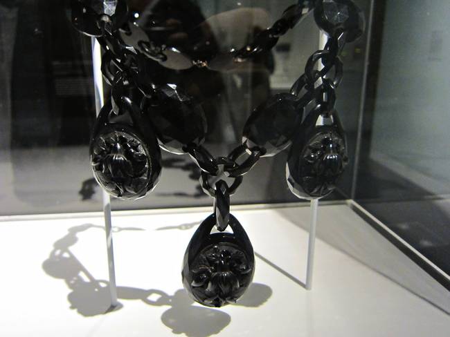 Jewelry was included in mourning attire, and was typically made of jet for its black color. Jet is a form of fossilized coal.