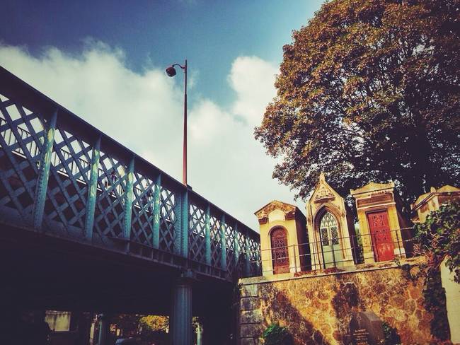 The colorful doors and the blue bridge make for a surprisingly cheerful scene.