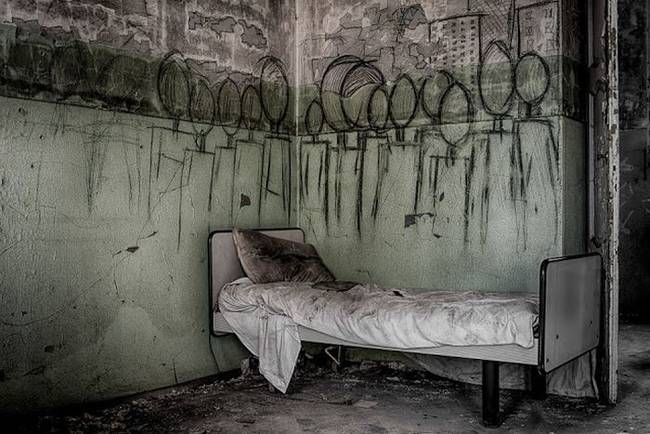 Creepy wall art from an abandoned mental institution in Italy.