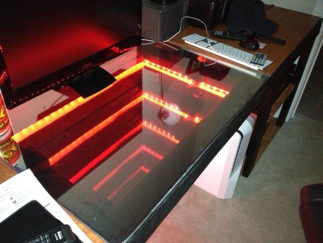 Get a little closer and look down into this desk's awesome infinity mirror equipped with LED lights!