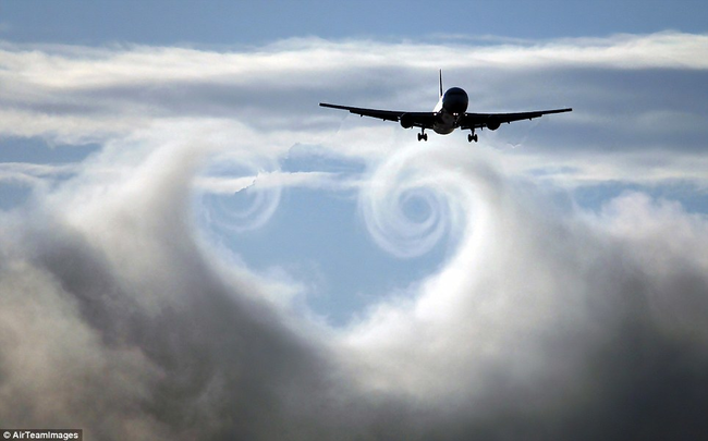 A passing plane creates swirls in the clouds.