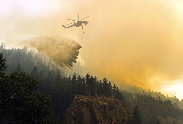 27.) Helicopter dropping water on a wildfire in Colorado.