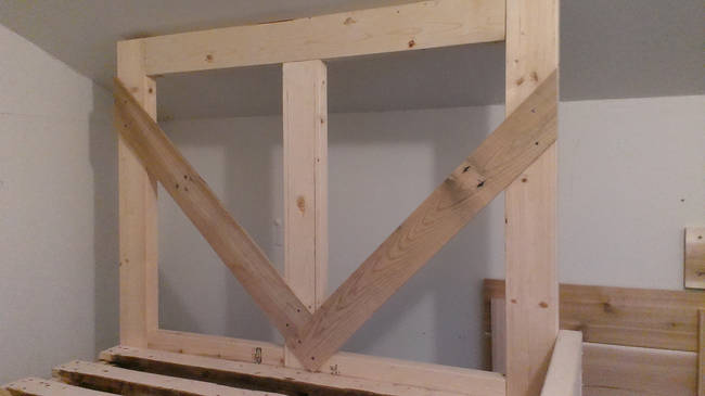 Finally, it was time to build the headboard. Still using the same wood pallets, he took to crafting a design.