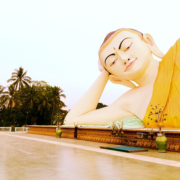 Anne is dwarfed in Myanmar. "Now that is one big Buddha!"